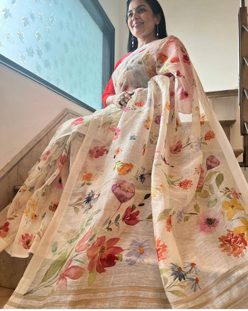 Woman wearing a floral saree with a blurred indoor background